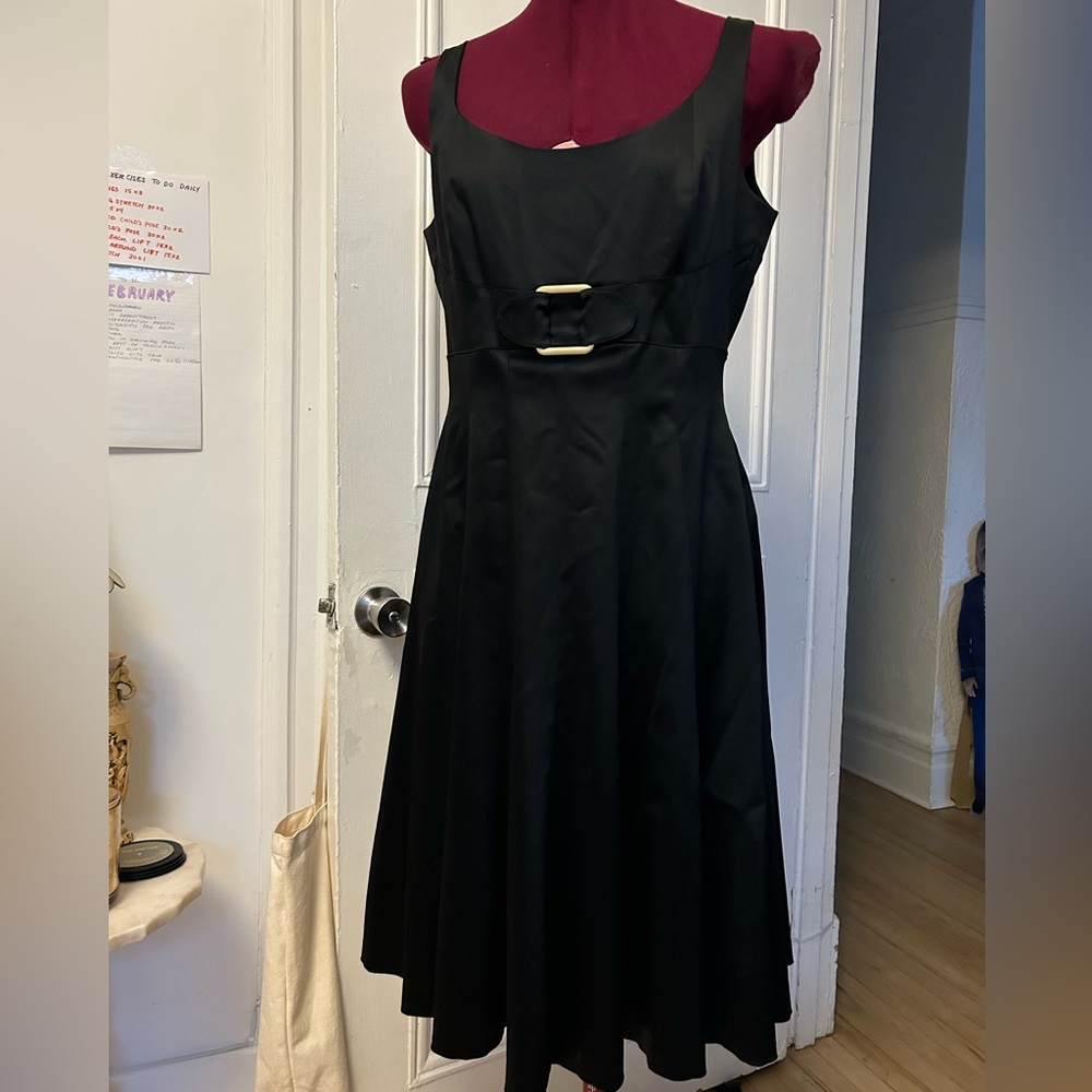 Elegant Black Sleeveless Dress with Golden Buckle